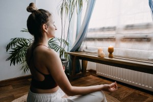 Woman sitting in a meditative pose.