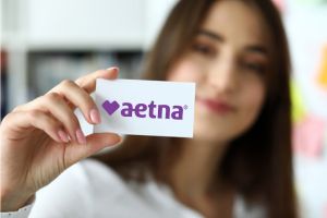 Person Holding Aetna Insurance Card