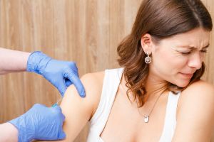 Someone who has trypanophobia, who is scared of needles, receives a shot.